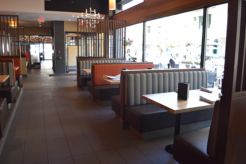 Wide view of grey and orange bench seating in a restaurant