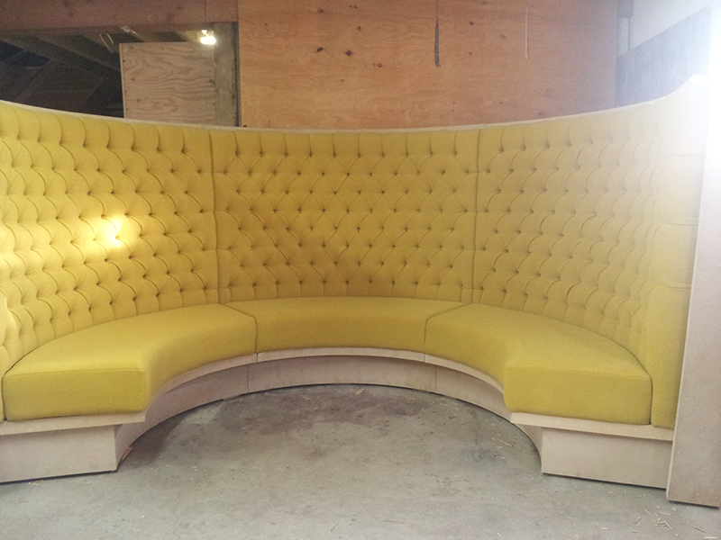 Yellow semi-circle seating in a restaurant